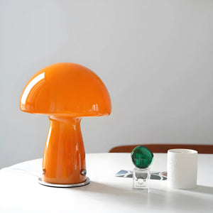 Bright orange mushroom-shaped table lamp with a glossy finish.