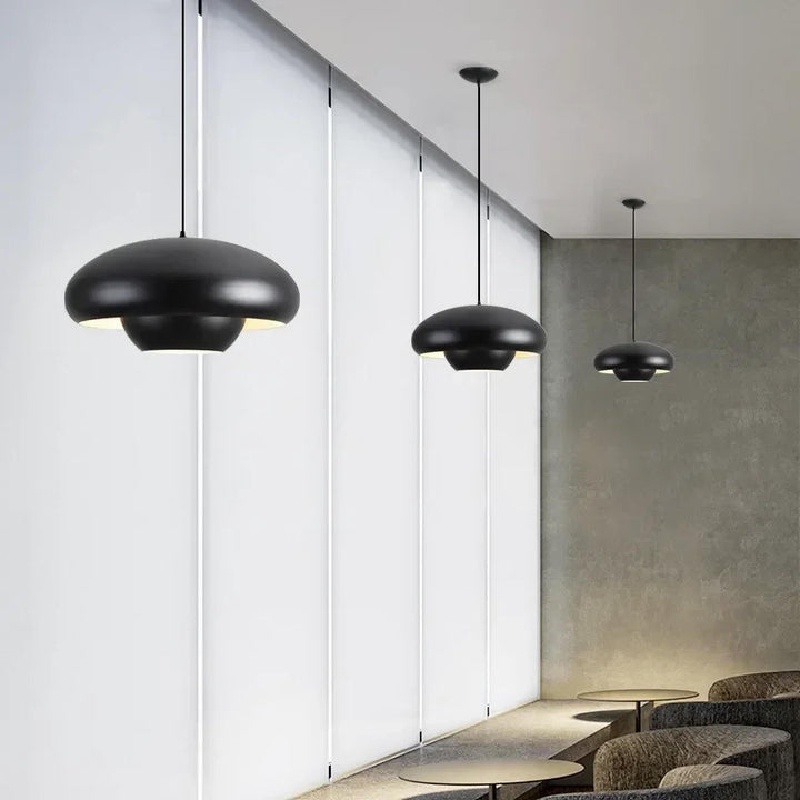 Black dome-shaped pendant light fixtures with a sleek, modern design.