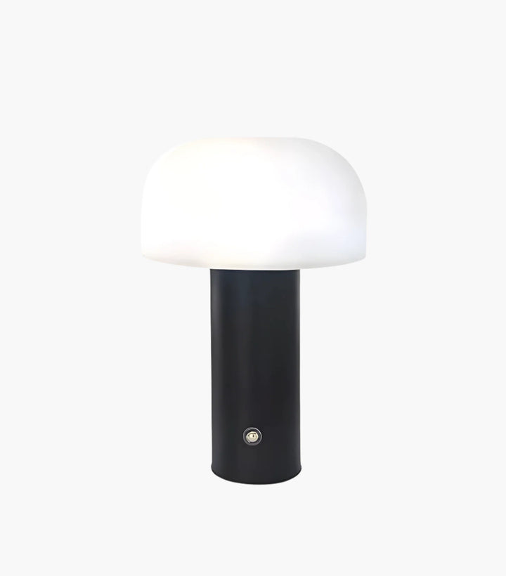 Modern table lamp with a black cylindrical base and white dome-shaped shade.