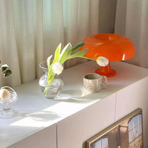 Bright orange mushroom-shaped table lamp.