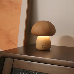 Mushroom-shaped lamp emitting a warm glow on a surface.