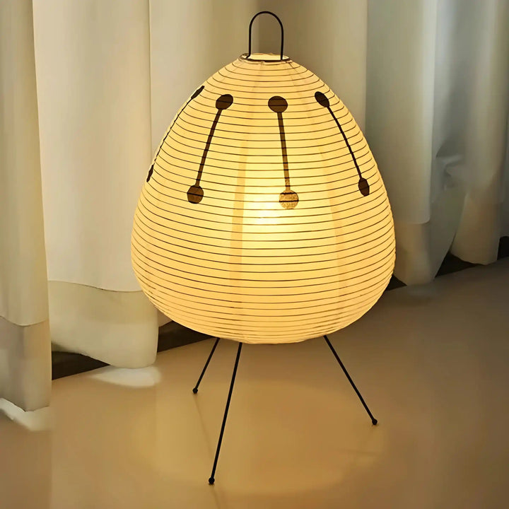 Egg-shaped paper lantern lamp with thin metal legs.