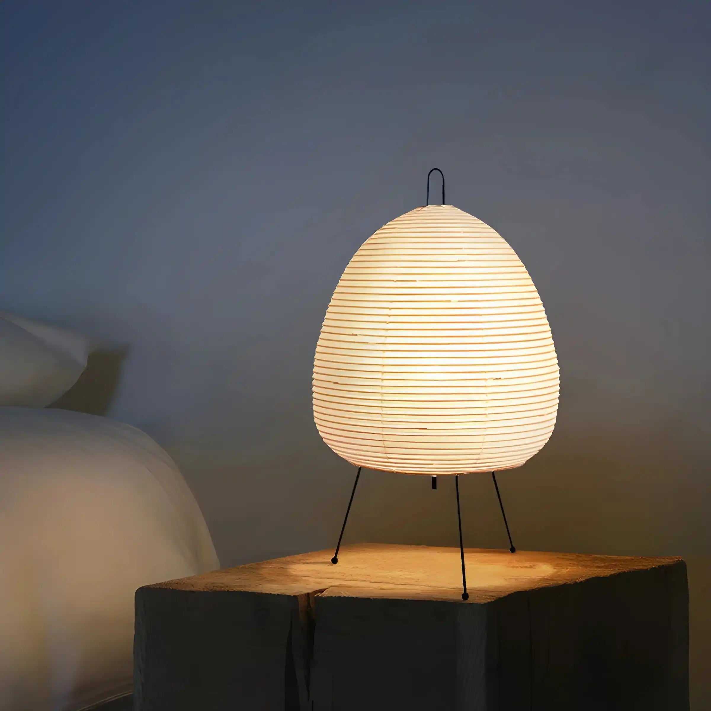 Egg-shaped paper lantern lamp on thin metal legs.