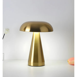 Gold-colored mushroom-shaped table lamp with a domed shade and cylindrical base.