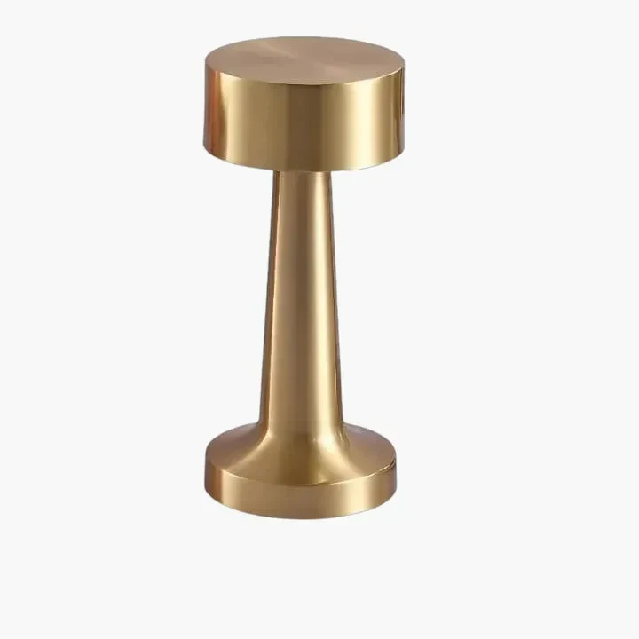 Gold-colored metal cylindrical object with a wider top and narrower base.