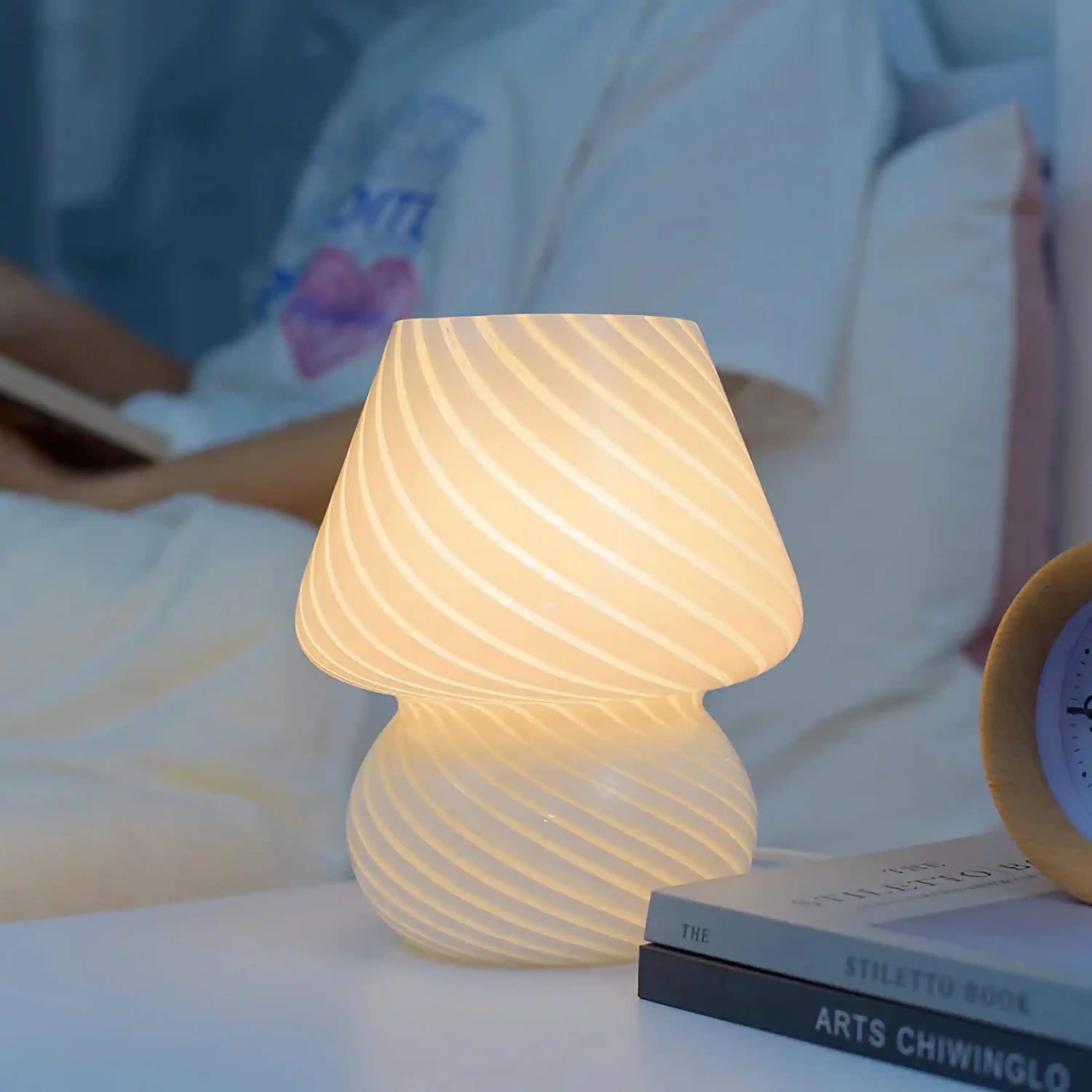 Illuminated mushroom-shaped table lamp with a textured, swirled pattern.