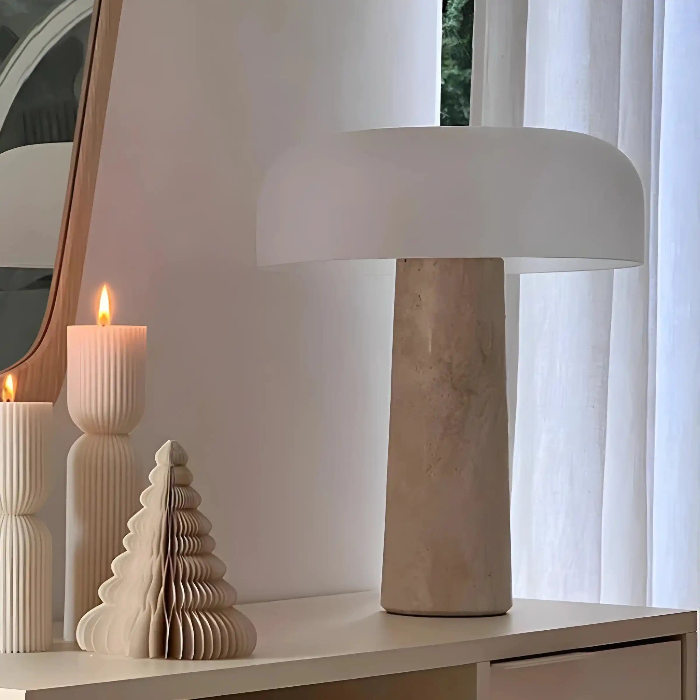 Modern table lamp with a stone-like base and wide, flat shade.