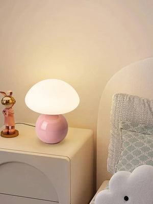 Mushroom-shaped table lamp with a pink base and white dome shade.