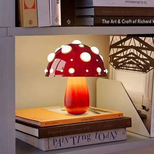 Mushroom-shaped table lamp with a red and white polka dot shade.