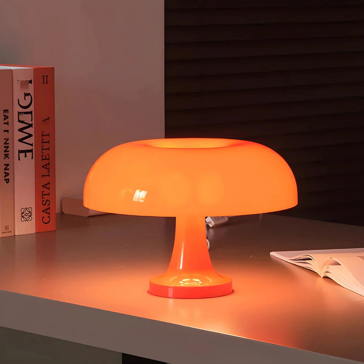 Orange mushroom-shaped table lamp with a glowing dome shade.