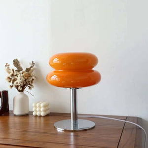 Orange mushroom-shaped table lamp with a metal base.