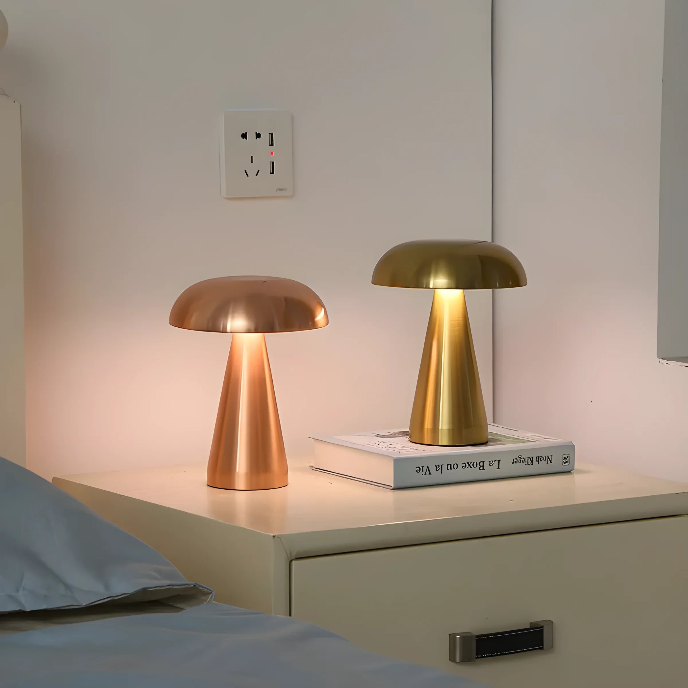 Pair of mushroom-shaped table lamps with metallic domes in copper and gold tones.