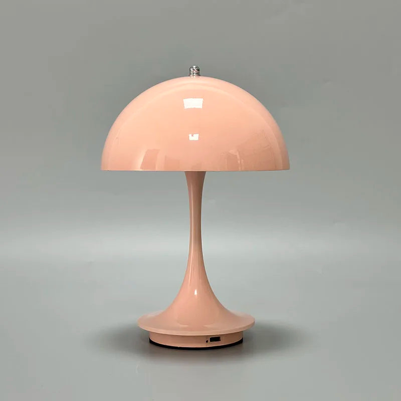 Pale pink mushroom-shaped table lamp with a domed shade.