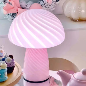 Pink mushroom-shaped table lamp with a swirled pattern on its cap.