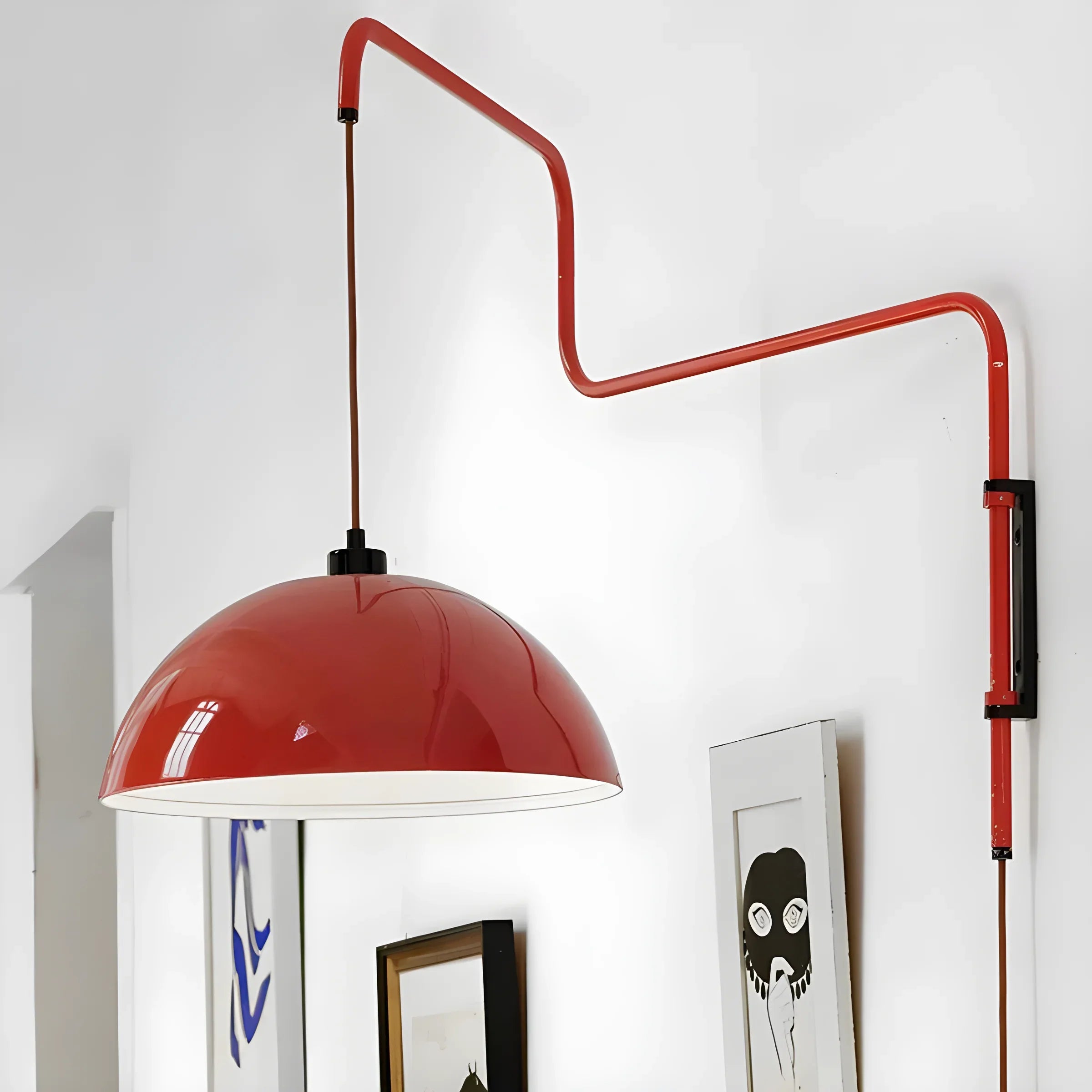 Red dome-shaped pendant lamp with a curved, adjustable wall-mounted arm.