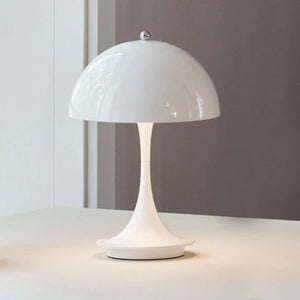 White dome-shaped table lamp with a slender stem and circular base.