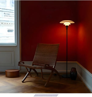 Woven wooden lounge chair with angled legs and backrest.