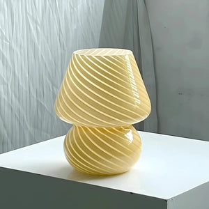 Yellow glass mushroom-shaped lamp with spiral ridges.